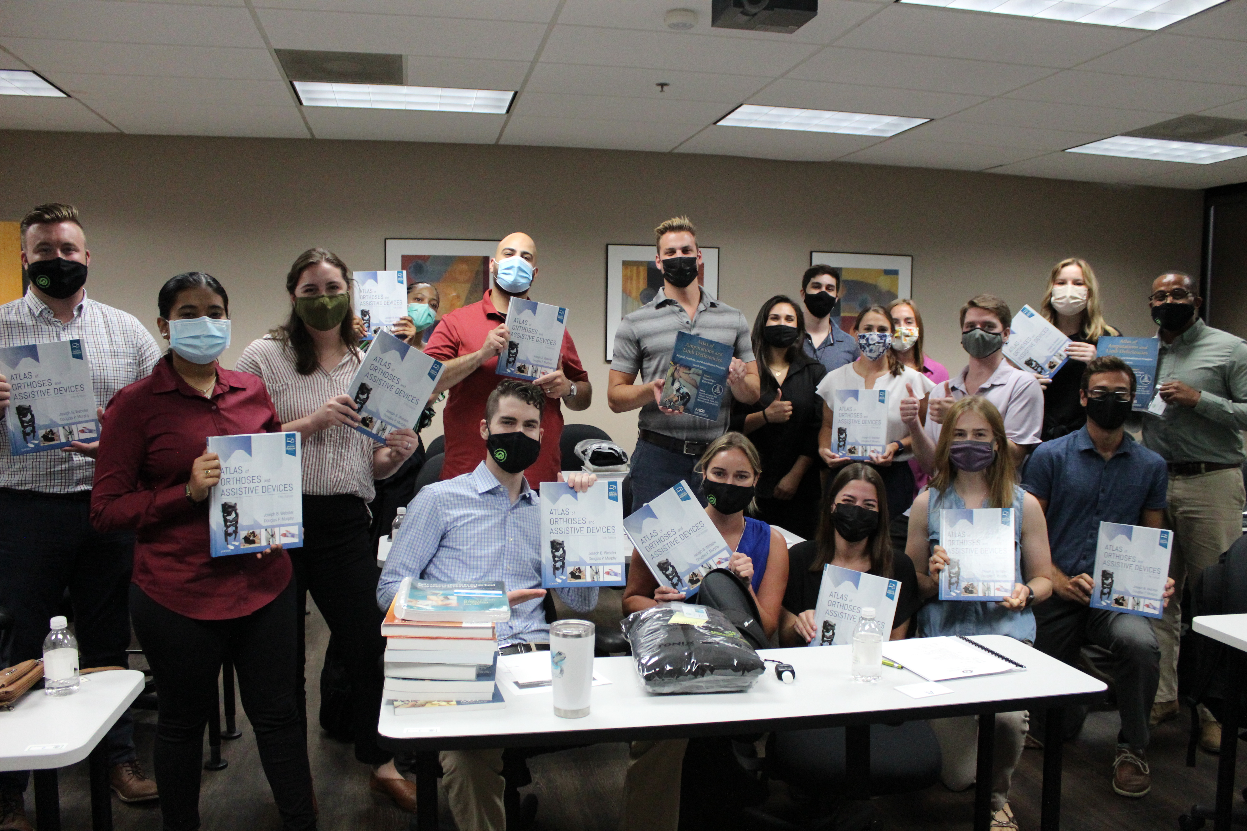 FIU/IIOP MSOP students holding up gifted atlases from ABC